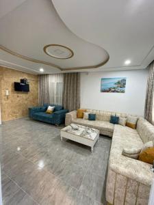 a living room with two couches and a table at Entire villa two floors sea view-Chatt Mariem in Sousse +32 photos