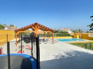 a playground with a pool and a pavilion at Villa Rio Salado in Alhaurín de la Torre