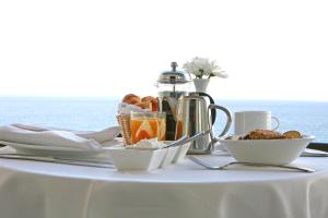 a table with a white table cloth with food on it at Crowne Plaza Limassol by IHG in Limassol