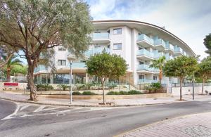 a building on a street with trees in front of it at Leonardo Suites Hotel Mallorca Calvia in Torrenova