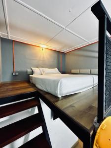 a bed in a small room on a boat at Ardour Lodge "A" Wing in Tanjung Bungah