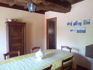 a dining room with a table with a vase on it at GITE LE FOUR DE SULIATUS in Seuillet