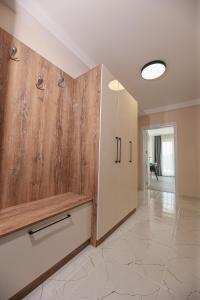 a large kitchen with wooden cabinets and a hallway at Lux Apartments Kranevo in Kranevo