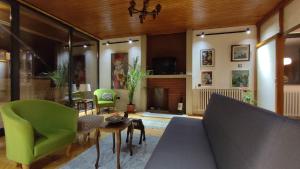 a living room with a couch and a fireplace at Central Apartment with Garden in Skopje