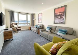 a living room with a couch and a tv at Chy Lowen in Newquay