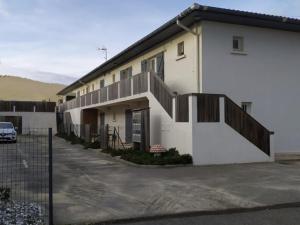 a white building with a balcony and a parking lot at Appartement Vieux-Boucau-les-Bains, 2 pièces, 4 personnes - FR-1-379-132 in Vieux-Boucau-les-Bains