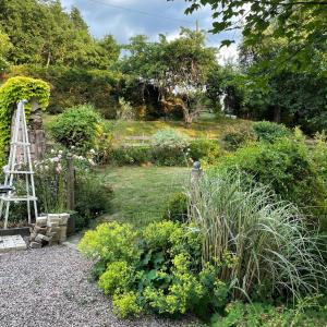 un jardín con una escalera y algunas plantas en Le moulin de l Epine, en Taintrux