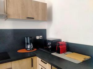 a kitchen with a coffee maker on a counter at Le Grand Saint Antoine in Saint-Jean-de-Maurienne