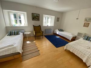 a living room with two beds and a chair at Sostrup Slot in Gjerrild