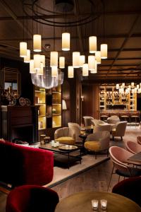 a lobby with chairs and tables and a chandelier at Maison Rouge Strasbourg Hotel & Spa, Autograph Collection in Strasbourg