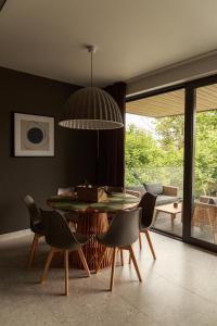 a dining room with a table and chairs at Campo Resort in Duszniki Zdrój