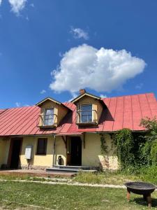 a house with a red roof at Neimaņu sēta Apartments in Augšlīgatne