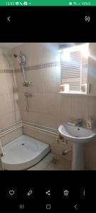 a bathroom with a sink and a tub and a toilet at Casa Ana in Eforie Sud +11 photos