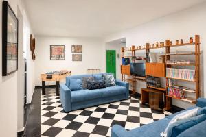 a living room with a blue couch and a table at Genoese design city apartment in Genova