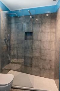 a bathroom with a shower and a toilet at Genoese design city apartment in Genova +38 photos