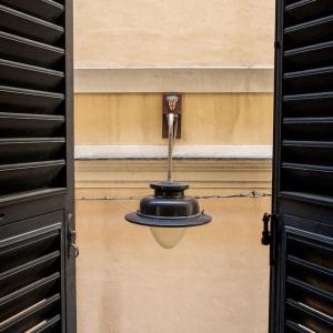 a light hanging from the side of a building at Genoese design city apartment in Genova