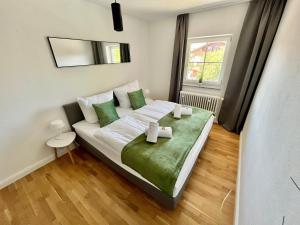 a bedroom with a bed with two candles on it at STAYBEST Apartment König Ludwig in Prien am Chiemsee