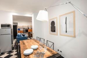a kitchen and dining room with a wooden table at Genoese design city apartment in Genoa
