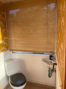 a small bathroom with a toilet and a sink at Lulani Hideaway by Air Vitesse in Áyios Pandeleḯmon