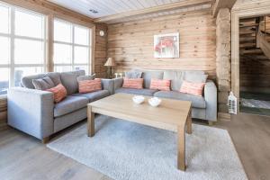 a living room with a couch and a coffee table at Stranda Fjellgrend in Stranda