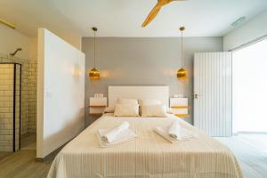 a bedroom with a large bed with two towels on it at Calas De Meca in Los Caños de Meca