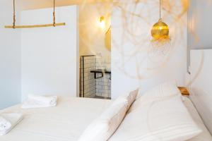 a bedroom with a white bed and a mirror at Calas De Meca in Los Caños de Meca