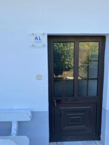a black door with a sign on the side of a building at Casa da Amendoeira Covelinhas in Peso da Régua +44 photos
