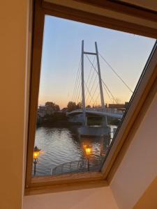 ミコワイキにあるNowe - Apartamenty Sunset Mikołajkiの川の景色を望む窓(橋付)
