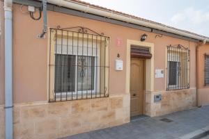 a building with bars on the side of it at Geranio in Caserío Bacarot