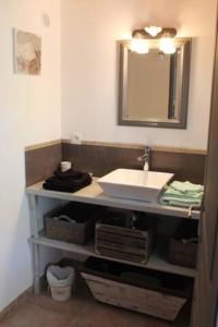 a bathroom with a sink and a mirror at AU MAS D'EMMA in Bourg-Saint-Andéol