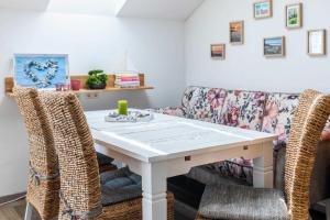 a dining room with a white table and chairs at Haus Seeblick Wohnung 16 in Wohlenberg