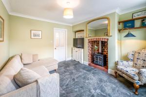 a living room with a couch and a fireplace at Pass the Keys Stylish newly renovated Victorian 2 bedroom house in Shrewsbury