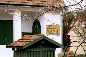 a house with a sign on the side of it at Flórián Vendégház in Villánykövesd