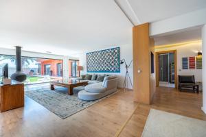 a living room with a couch and a table at Unique Villa -1 km to Beach, private Natural pool, Tennis Court & Jumping Mat in Sagres +33 photos
