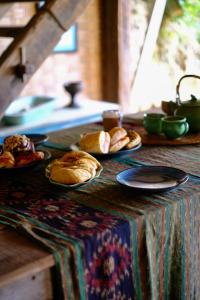 a table with plates of pastries on top of it at The Island Houses Bingin in Uluwatu