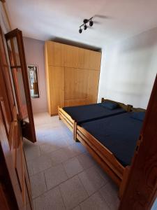 a bedroom with a large bed with a blue comforter at Meltemi Apartments in Asprovalta
