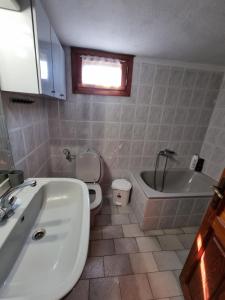 a bathroom with a tub and a toilet and a sink at Meltemi Apartments in Asprovalta +11 photos