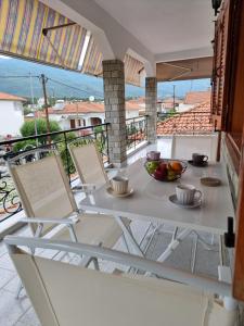 a white table and chairs on a balcony at Meltemi Apartments in Asprovalta