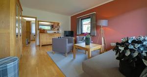 a living room with a couch and a table at Seehaus Verena in Weissensee
