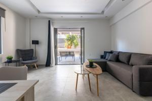 a living room with a couch and a table at Greyt Apartments Glyfada in Athens