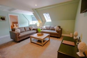 a living room with a couch and a table at Woodfalls Inn in Redlynch