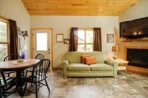 a living room with a couch and a table at Lakefront Wisconsin Cabin Dock, Walk to Beach! 