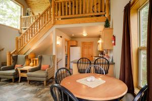 a kitchen and dining room with a table and chairs at Lakefront Wisconsin Cabin Dock, Walk to Beach! 
