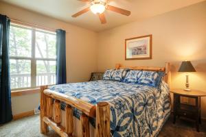 a bedroom with a bed and a ceiling fan at Lakefront Wisconsin Cabin Dock, Walk to Beach! 