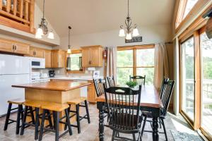 a kitchen with a wooden table and chairs at Lakefront Wisconsin Getaway with Kayak and Boat Dock! 