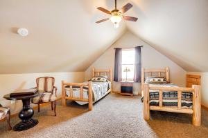 a attic bedroom with two beds and a ceiling fan at Lakefront Wisconsin Getaway with Kayak and Boat Dock! 