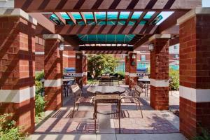 a patio with a table and chairs under a pergola at Hyatt House Philadelphia/Plymouth Meeting in East Norriton
