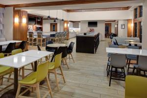 ein Restaurant mit Tischen und Stühlen und eine Bar in der Unterkunft Hyatt House Philadelphia/Plymouth Meeting in East Norriton