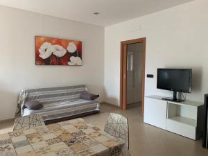 a living room with a couch and a tv at CORTE COLOMBARON vicino a Gardaland in Ronchi