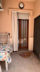 a bedroom with a bed and a door with a window at Drè Marèna in Rimini